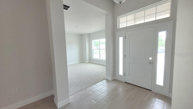 view of carpeted foyer entrance