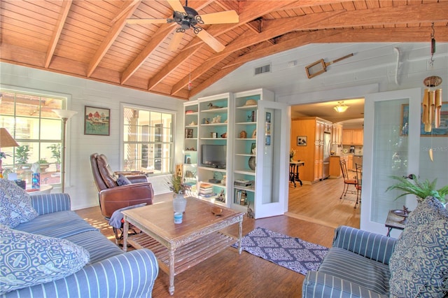 living room with hardwood / wood-style flooring, ceiling fan, vaulted ceiling with beams, and wooden ceiling