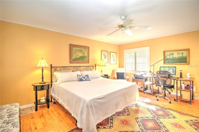 bedroom featuring crown molding, light hardwood / wood-style flooring, and ceiling fan