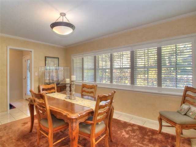 tiled dining space featuring crown molding