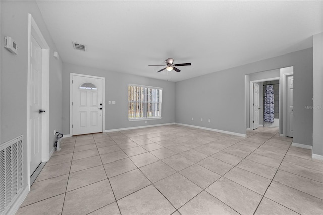 entryway with ceiling fan and light tile patterned floors