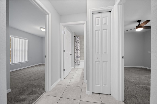 hallway featuring light colored carpet