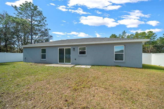 back of property with a patio area and a lawn