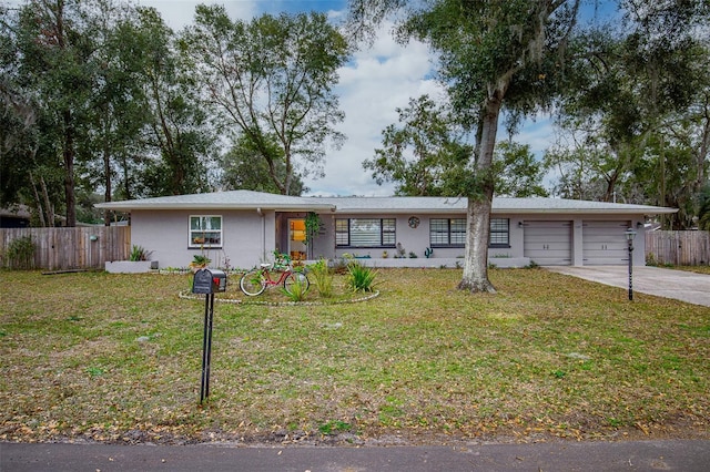 ranch-style house with a front yard and a garage