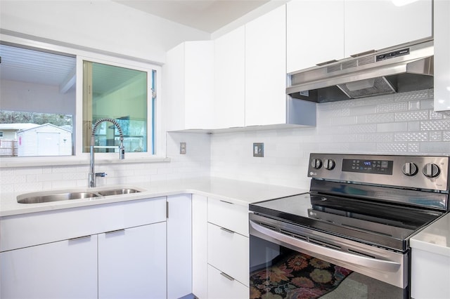 kitchen with white cabinets, backsplash, electric range, and sink