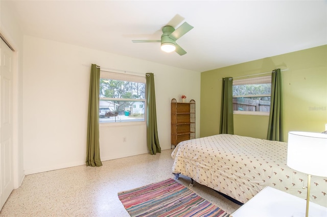 bedroom featuring multiple windows and ceiling fan