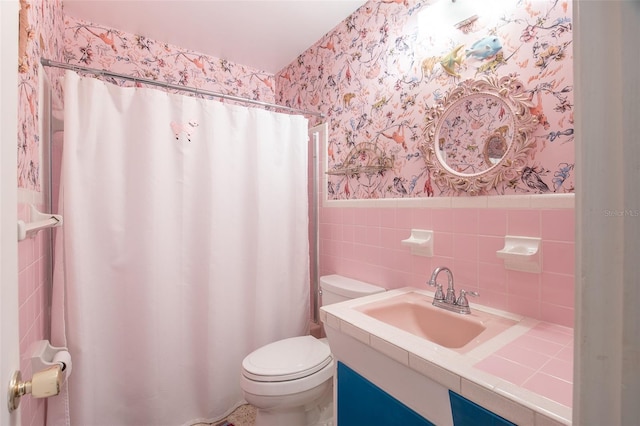 bathroom featuring toilet, tile walls, walk in shower, and vanity