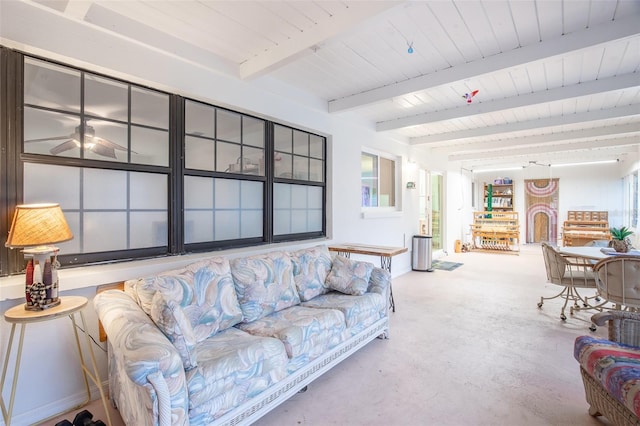 living room with concrete floors and beam ceiling