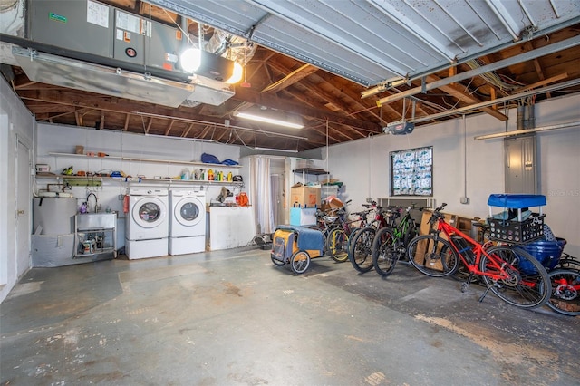 garage featuring a garage door opener, electric panel, and washer and dryer