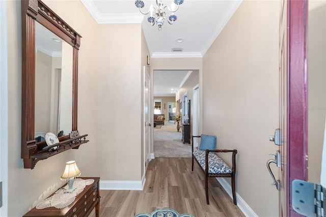 hall featuring light hardwood / wood-style flooring and ornamental molding