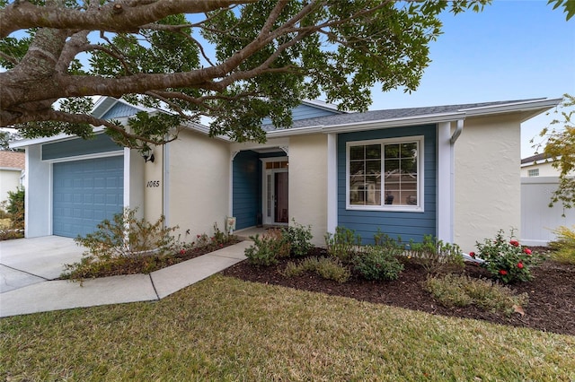 single story home with a garage and a front lawn