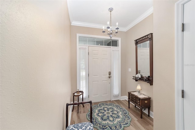 entrance foyer with crown molding, an inviting chandelier, and hardwood / wood-style floors