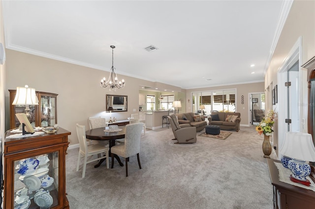 carpeted dining room with crown molding and a chandelier