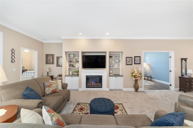 living room with crown molding, built in shelves, and carpet floors