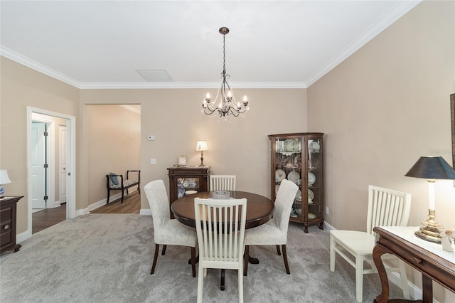 carpeted dining area with an inviting chandelier and crown molding