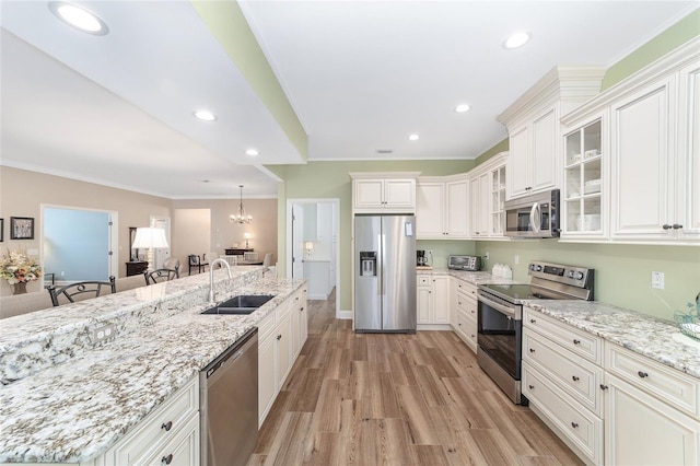 kitchen featuring stainless steel appliances, sink, and white cabinets