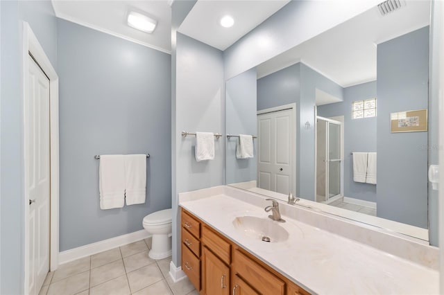 bathroom with vanity, tile patterned flooring, a shower with door, and toilet