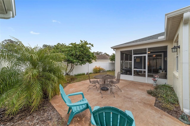 view of patio featuring a sunroom