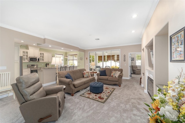 living room featuring light carpet, baseboards, a glass covered fireplace, crown molding, and recessed lighting