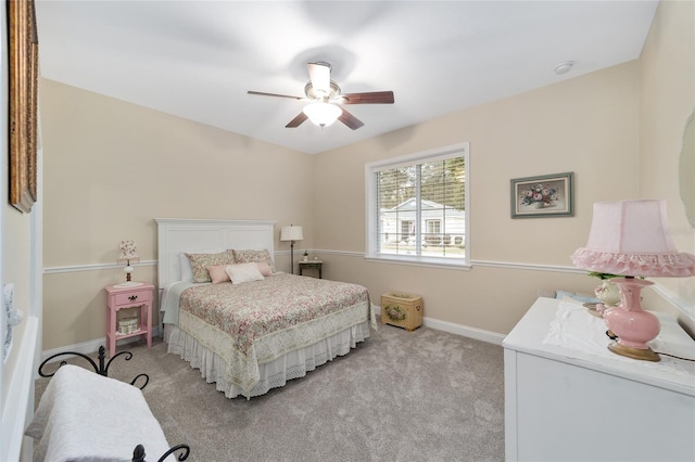 bedroom with ceiling fan, baseboards, and light colored carpet