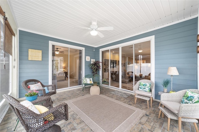 sunroom featuring ceiling fan