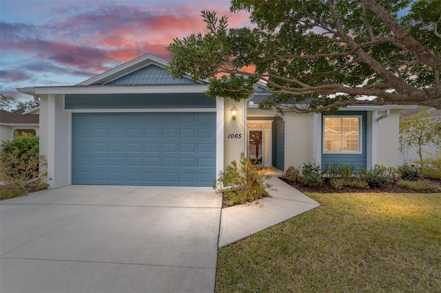 1065 NE 31st Ter, Ocala, FL 34470 - view of front of property featuring concrete driveway, a front lawn, stucco siding, and a garage