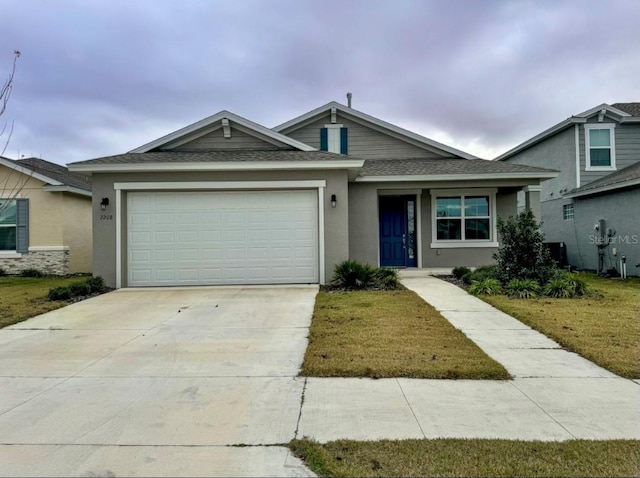 view of front of house with a garage and a front lawn