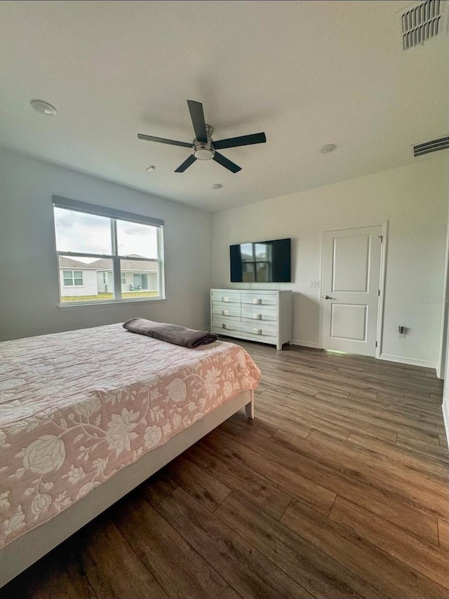 bedroom with ceiling fan and hardwood / wood-style flooring