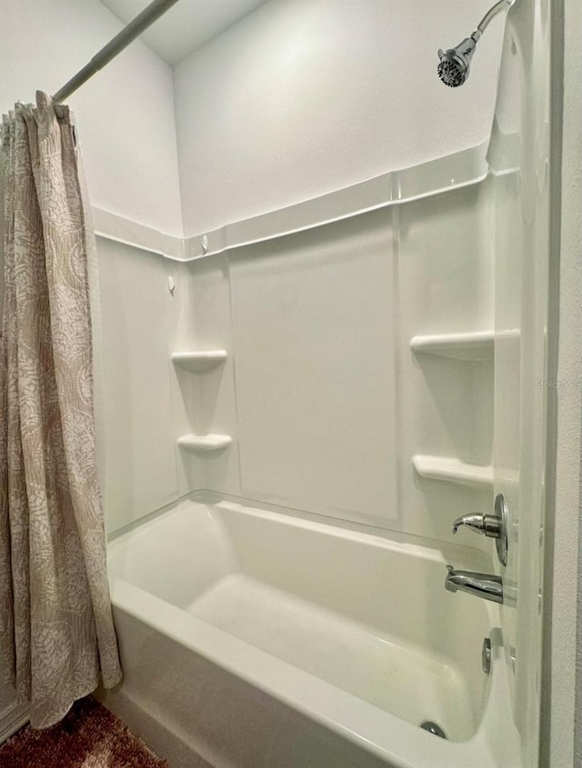 bathroom featuring shower / tub combo with curtain