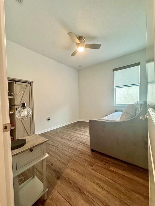 unfurnished bedroom with dark hardwood / wood-style floors and ceiling fan