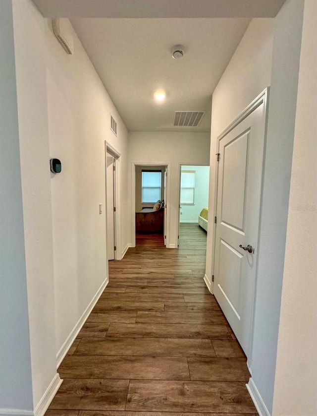 hall with dark hardwood / wood-style floors