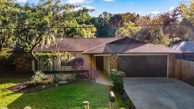 ranch-style house featuring a garage and a front yard