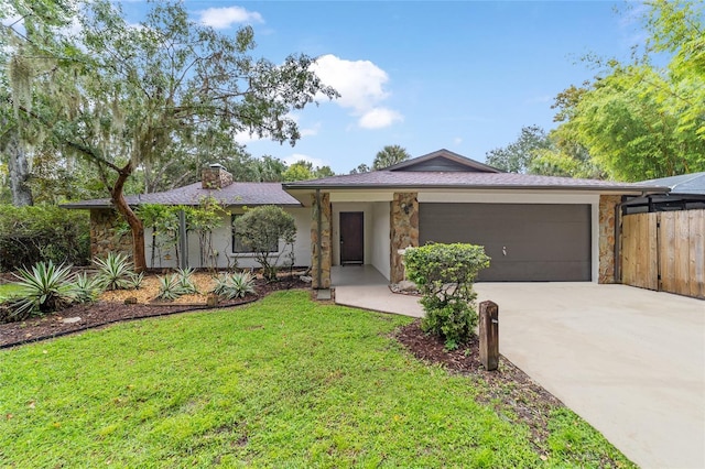 ranch-style home with a garage and a front yard