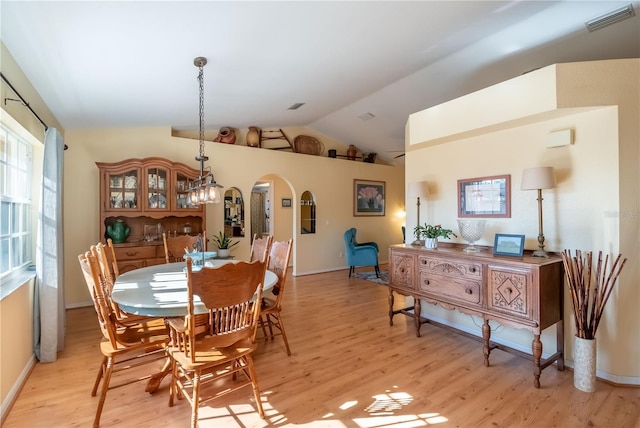 dining area featuring light hardwood / wood-style floors and vaulted ceiling