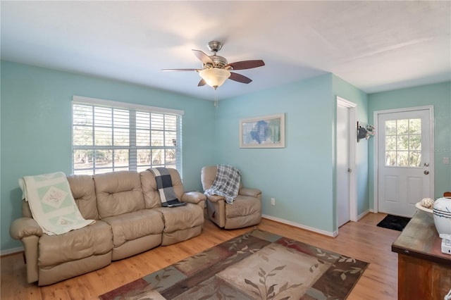 living room featuring ceiling fan and light wood-type flooring