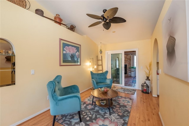 sitting room with light hardwood / wood-style flooring, ceiling fan, and vaulted ceiling