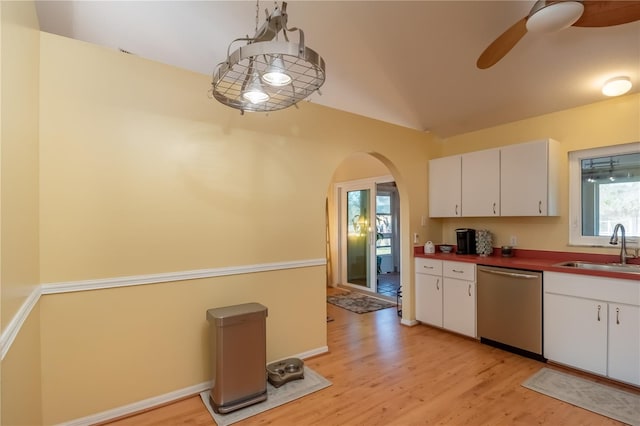 kitchen with sink, white cabinetry, vaulted ceiling, hanging light fixtures, and dishwasher