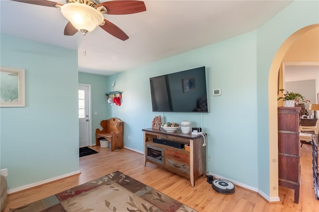 living room with ceiling fan and light wood-type flooring