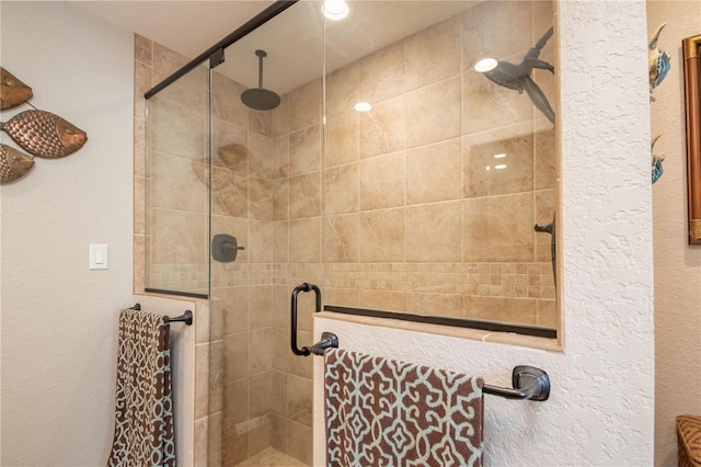 bathroom with a shower with shower door