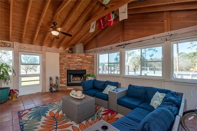 living room featuring wood ceiling, a large fireplace, plenty of natural light, and lofted ceiling with beams