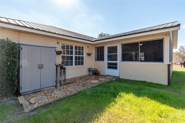 back of property featuring a lawn