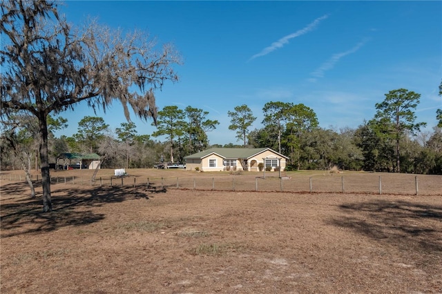 view of yard with a rural view