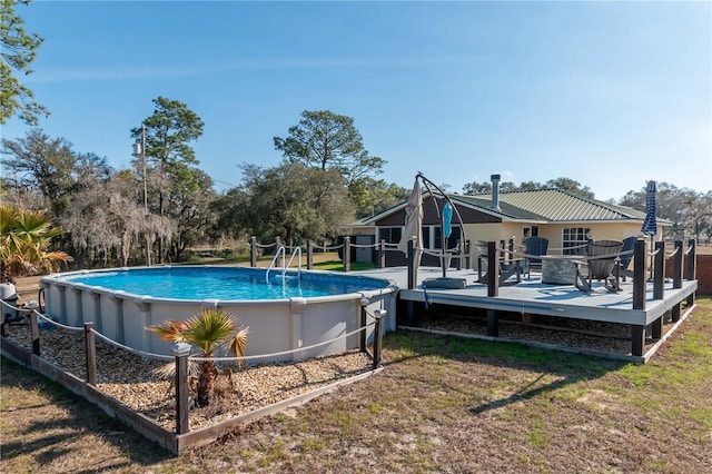 view of swimming pool featuring a wooden deck and a yard