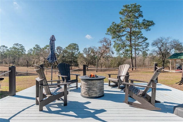 wooden terrace featuring an outdoor fire pit