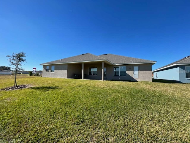 rear view of property with a yard