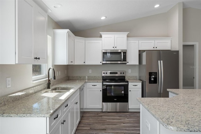 kitchen featuring white cabinetry, appliances with stainless steel finishes, sink, and lofted ceiling