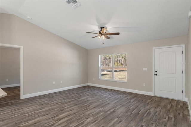 spare room with vaulted ceiling, dark hardwood / wood-style floors, and ceiling fan