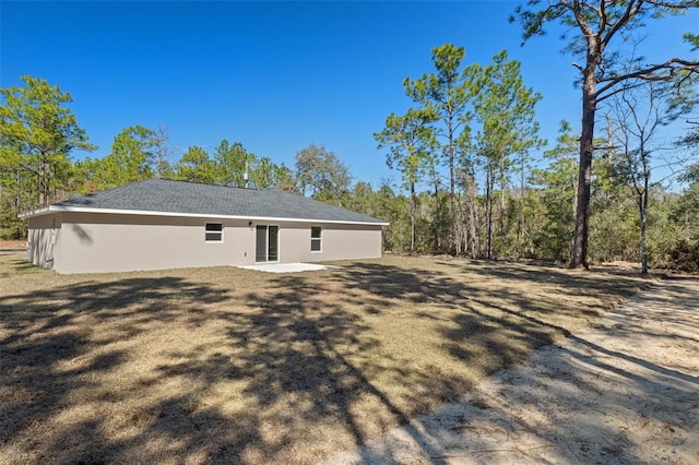 rear view of house featuring a yard