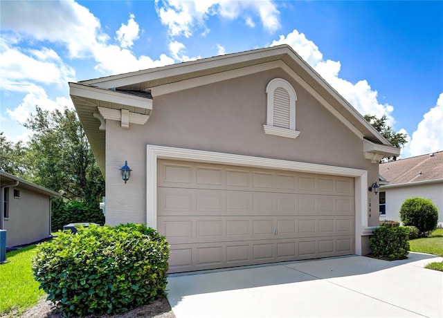 view of front of property with cooling unit and a garage