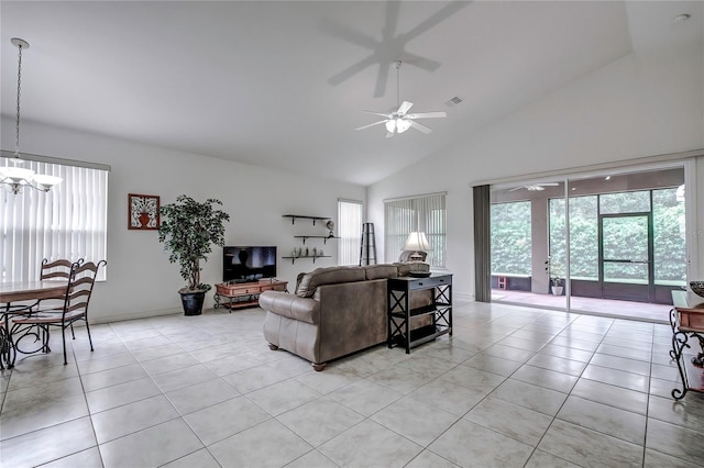 living room featuring light tile patterned flooring, ceiling fan with notable chandelier, and high vaulted ceiling